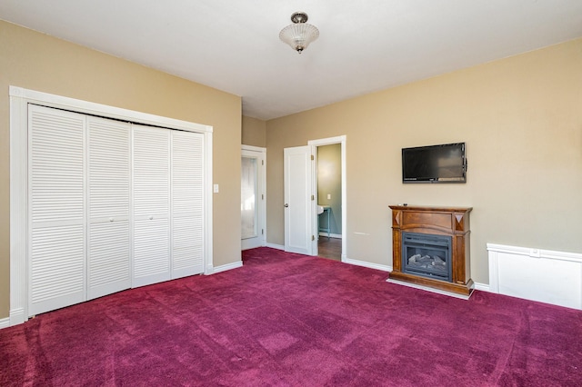 unfurnished bedroom with carpet and a closet