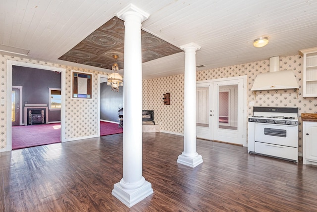 interior space featuring premium range hood, dark wood-type flooring, white gas range oven, decorative light fixtures, and wood ceiling