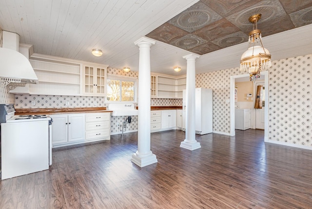 kitchen featuring pendant lighting, dark hardwood / wood-style floors, white electric range oven, white cabinetry, and butcher block counters