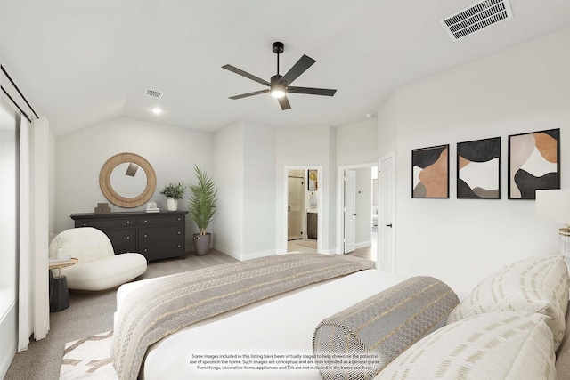 carpeted bedroom featuring ensuite bathroom, lofted ceiling, and ceiling fan