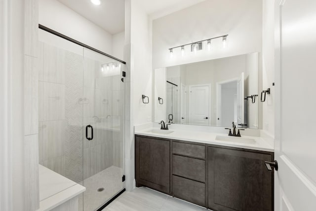 bathroom with vanity, an enclosed shower, and tile patterned flooring