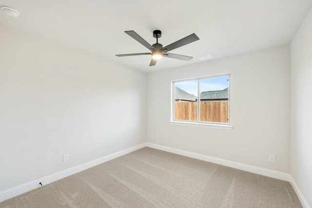 empty room with ceiling fan and carpet flooring