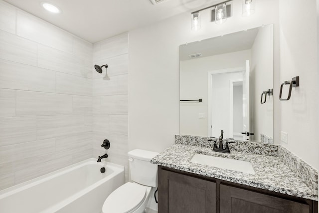 full bathroom featuring vanity, toilet, and tiled shower / bath combo