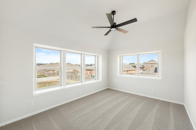 unfurnished room with ceiling fan, vaulted ceiling, and carpet