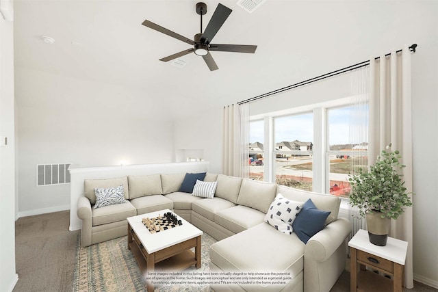 carpeted living room with ceiling fan