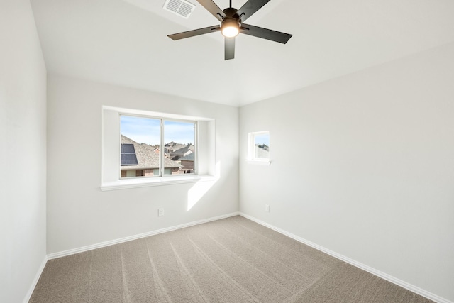 spare room featuring carpet floors and ceiling fan