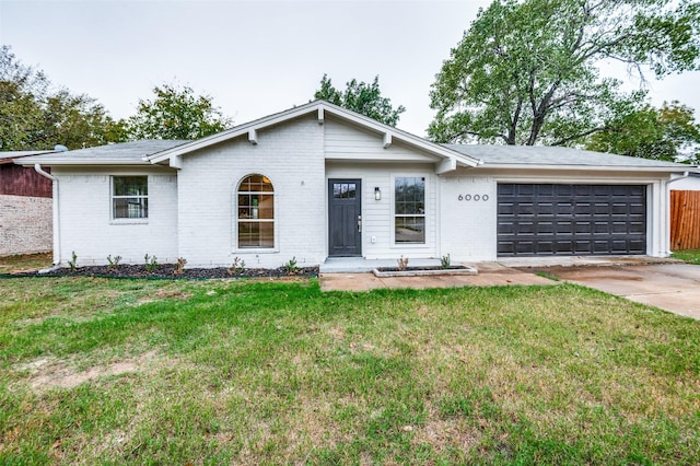 ranch-style house featuring a garage and a front lawn