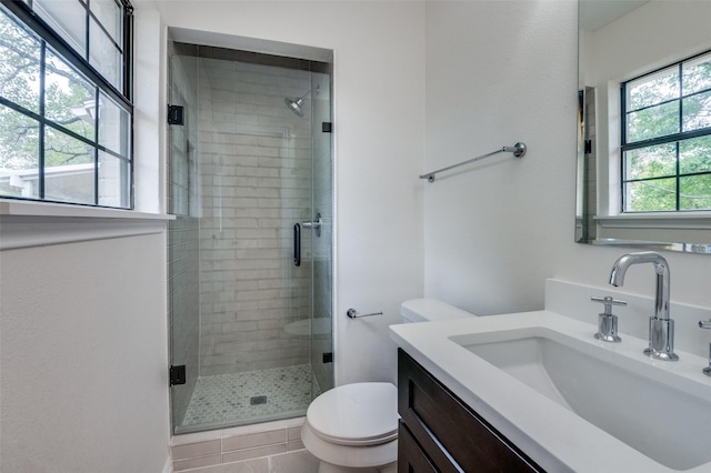 bathroom featuring walk in shower, tile patterned flooring, vanity, and toilet