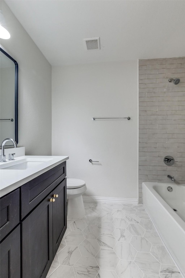 full bathroom featuring vanity, toilet, and tiled shower / bath