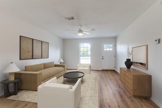 living room with ceiling fan and light hardwood / wood-style floors