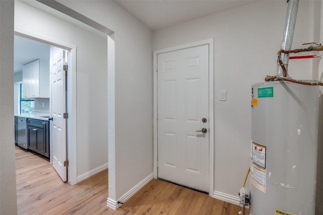 foyer with light hardwood / wood-style floors and gas water heater