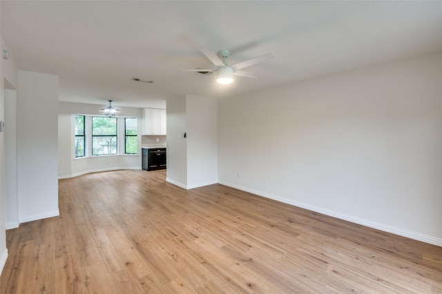 unfurnished living room featuring ceiling fan and light hardwood / wood-style floors