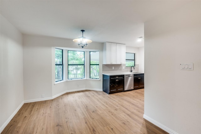 kitchen featuring dishwasher, light hardwood / wood-style flooring, a wealth of natural light, and sink