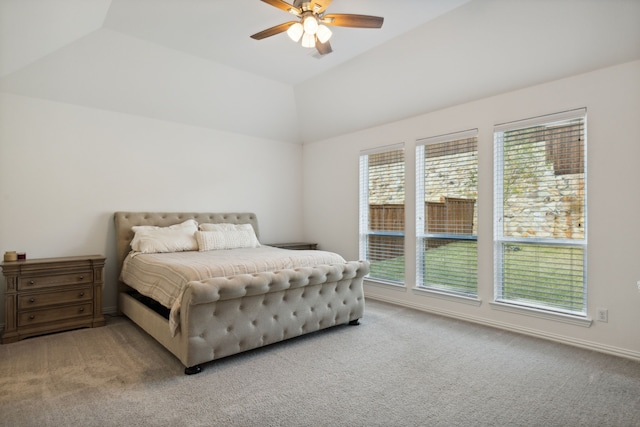 carpeted bedroom with multiple windows, lofted ceiling, and ceiling fan