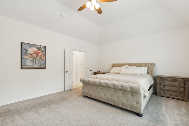 bedroom featuring vaulted ceiling, light carpet, and ceiling fan