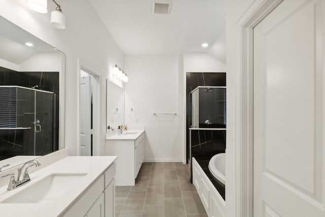 bathroom with vanity, vaulted ceiling, shower with separate bathtub, and tile patterned flooring