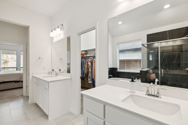 bathroom with vanity, tile patterned floors, and a shower with door