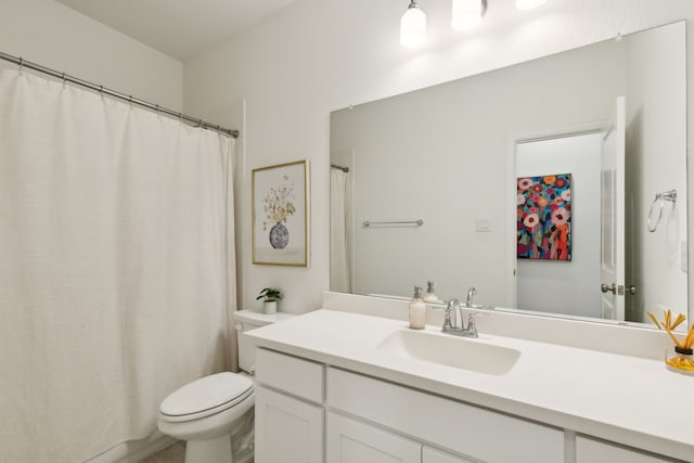 bathroom featuring toilet and vanity