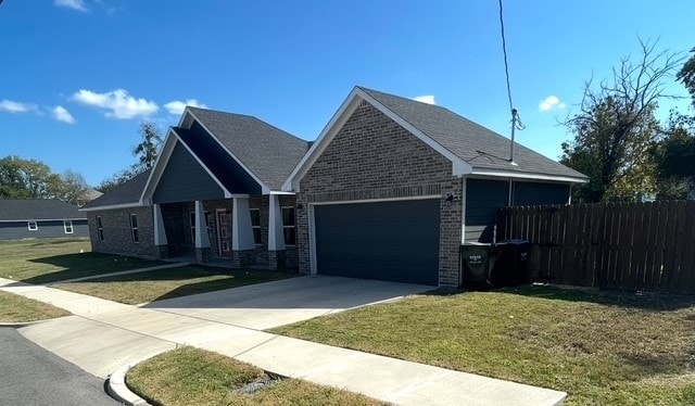 view of front of property featuring a front yard and a garage