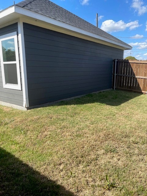 view of side of home featuring a lawn