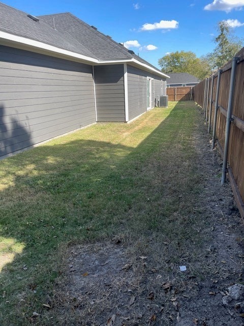 view of yard with central air condition unit