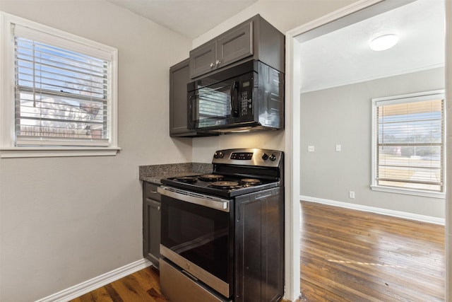 kitchen with baseboards, stainless steel electric range, black microwave, and dark wood-style floors