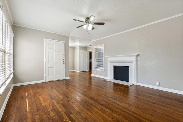 unfurnished living room featuring ornamental molding, ceiling fan, wood finished floors, and a fireplace