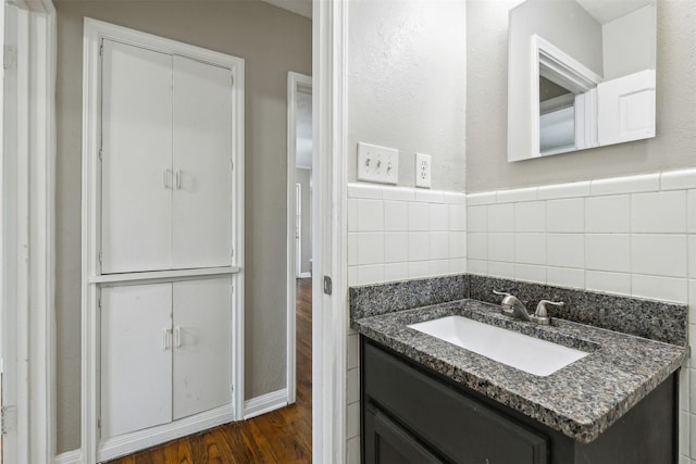 bathroom with vanity, baseboards, and wood finished floors