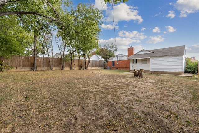 view of yard with a fenced backyard
