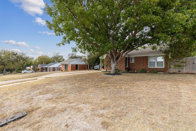 single story home featuring brick siding and fence