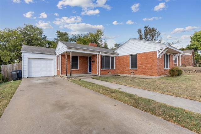 ranch-style home with a front yard, a chimney, brick siding, an attached garage, and driveway