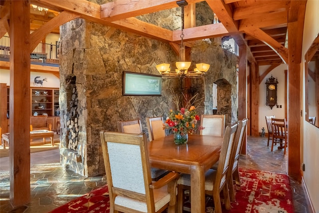 dining space featuring beam ceiling, high vaulted ceiling, and an inviting chandelier