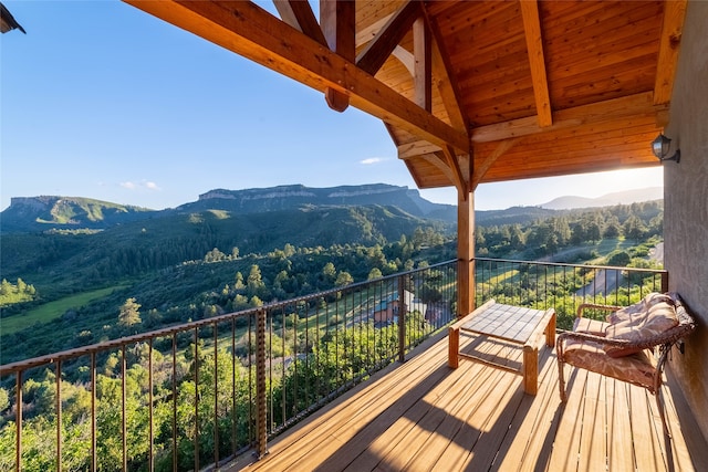 wooden deck with a mountain view