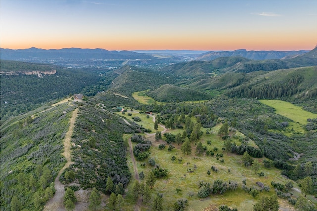 aerial view at dusk featuring a mountain view