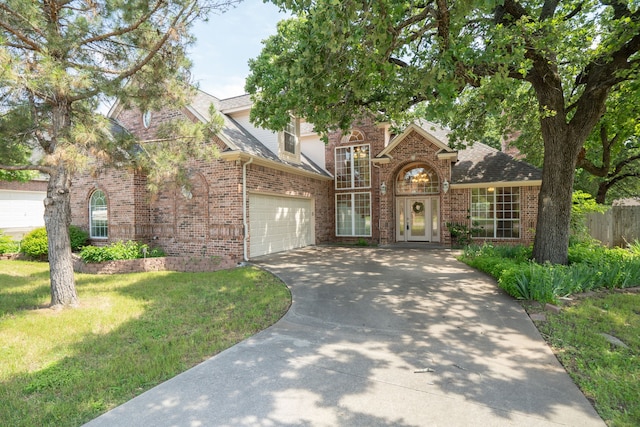 view of front of home with a front lawn and a garage