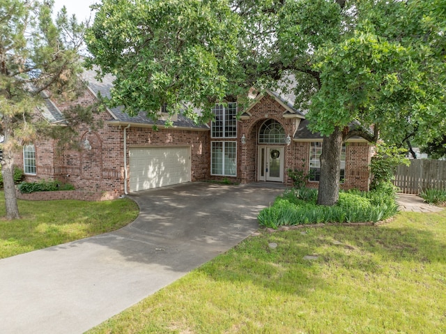 view of front of property with a garage and a front yard