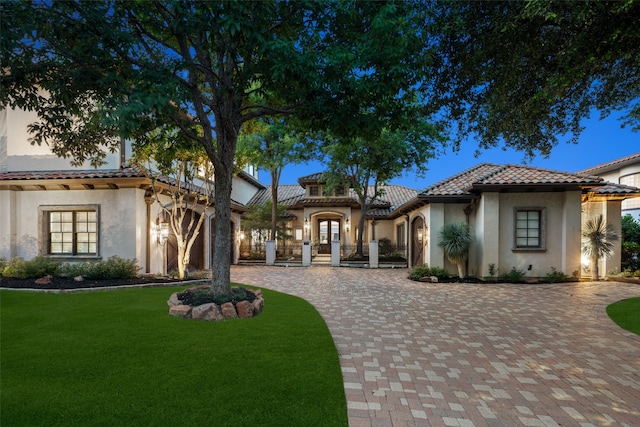 mediterranean / spanish-style house featuring a lawn