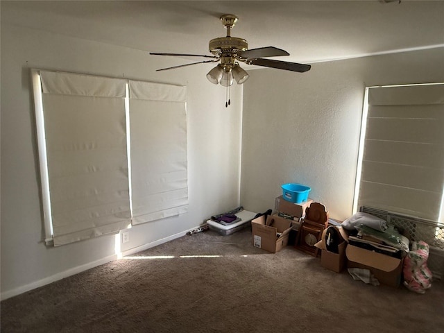 unfurnished bedroom with ceiling fan and carpet floors