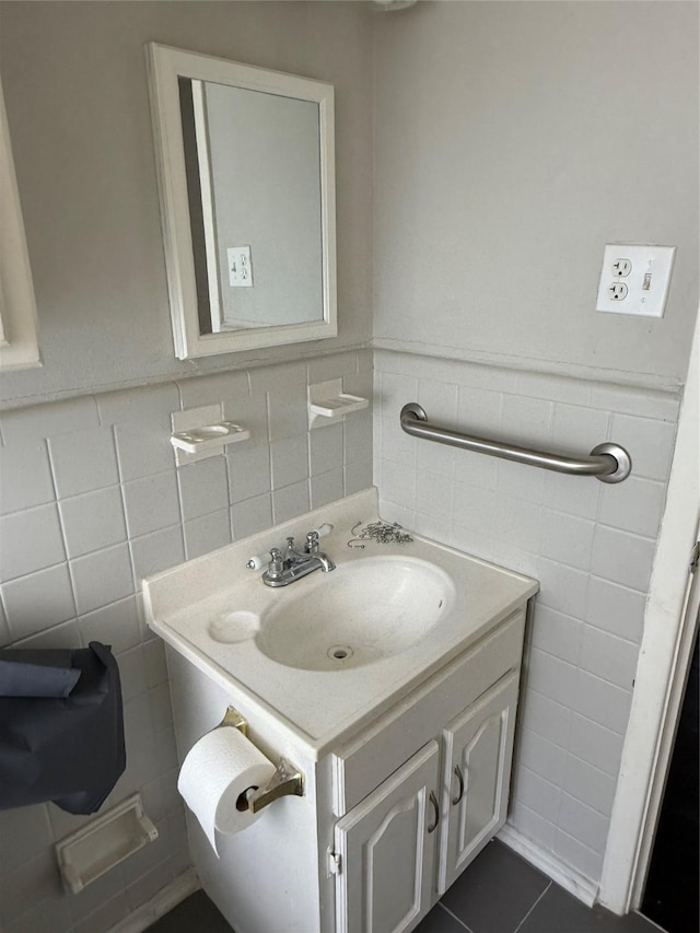 bathroom featuring tile patterned floors, vanity, and tile walls