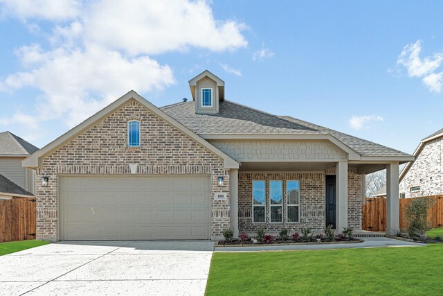 view of front facade featuring a garage and a front lawn