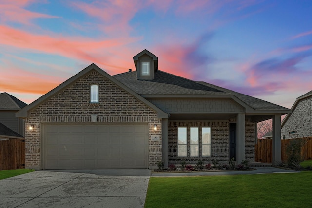 view of front facade featuring a garage and a lawn