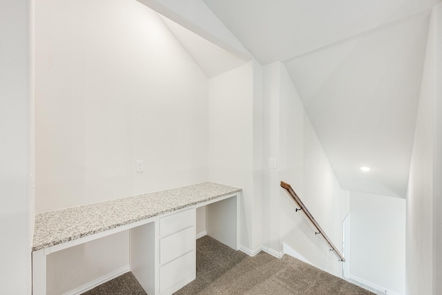 interior space with vaulted ceiling and carpet floors