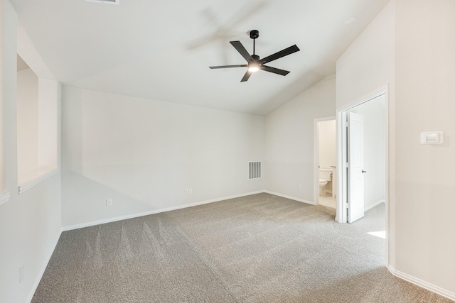 carpeted spare room with ceiling fan and lofted ceiling