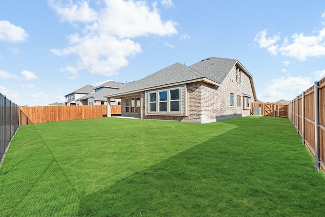back of house with a lawn