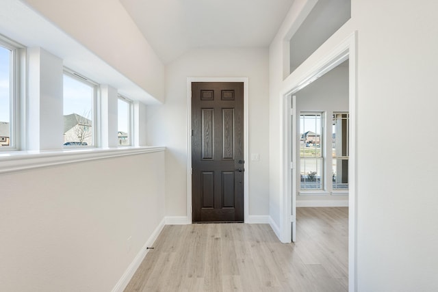 foyer with lofted ceiling and light hardwood / wood-style floors