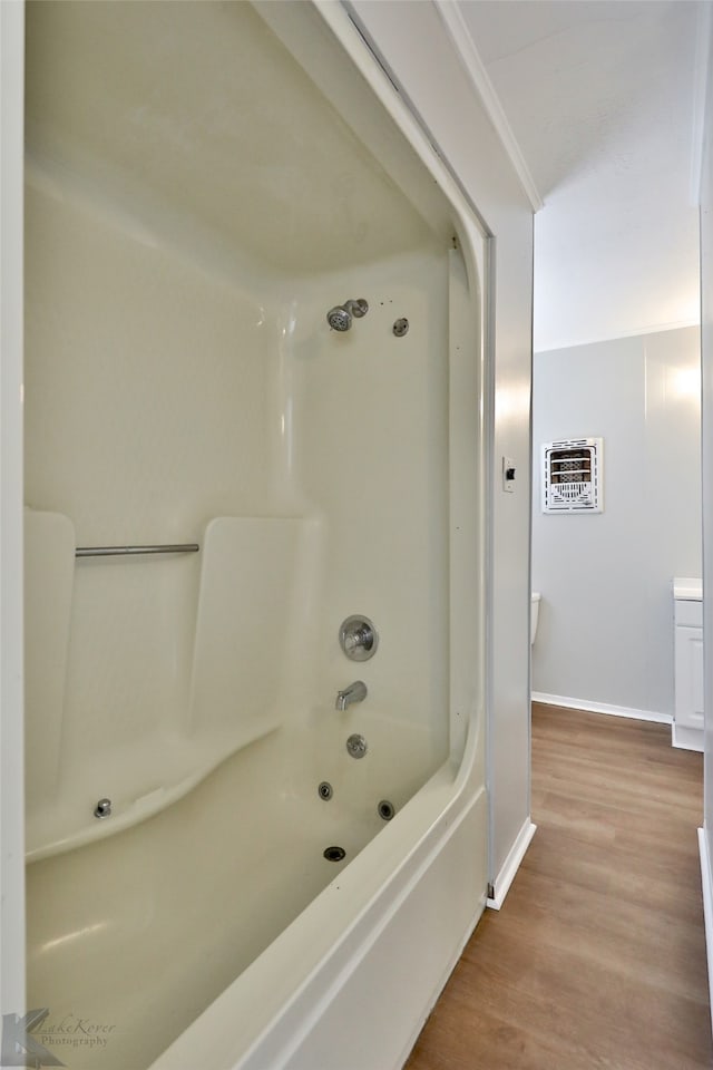 bathroom featuring shower / tub combination and hardwood / wood-style flooring