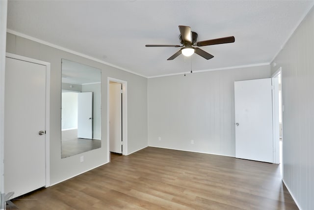 spare room featuring crown molding, hardwood / wood-style floors, and ceiling fan