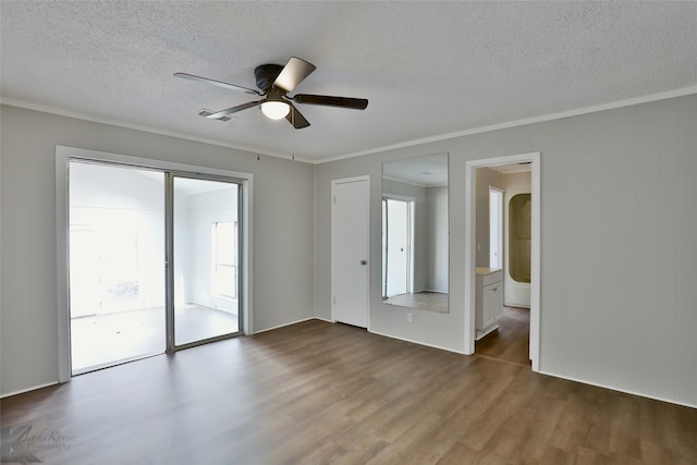 spare room with ceiling fan, hardwood / wood-style flooring, a textured ceiling, and ornamental molding