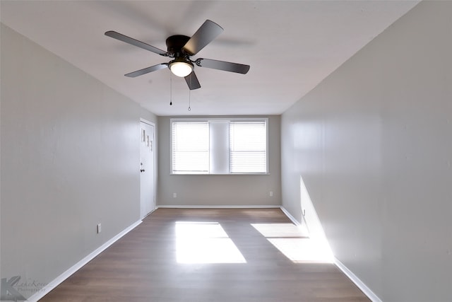 unfurnished room featuring ceiling fan and dark hardwood / wood-style flooring