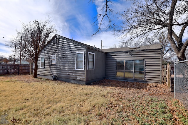 rear view of property with a yard